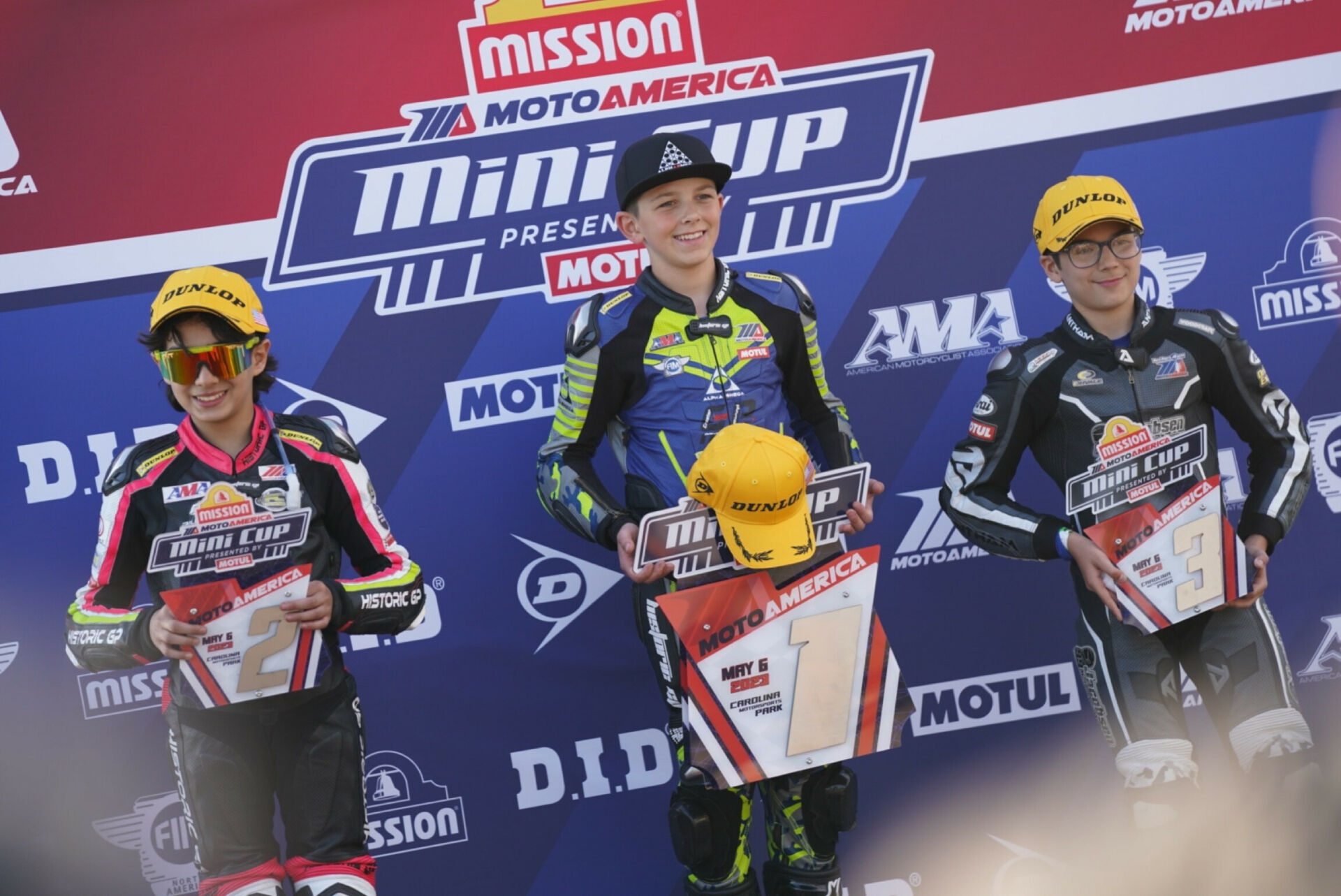 Mahdi Salem (left), Ryder Davis (center), and Nathan Bettencourt (right) celebrate their top-three finishes from the second Mission Mini Cup By Motul Ohvale 190 race at Carolina Motorsports Park. Photo courtesy MotoAmerica.