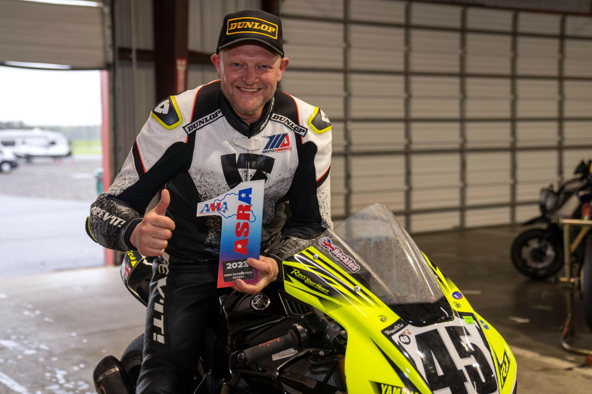 Mark Heckles poses with his trophy for winning the ASRA Superstock race at New Jersey Motorsports Park. Photo by Mark Lienhard, courtesy ASRA.