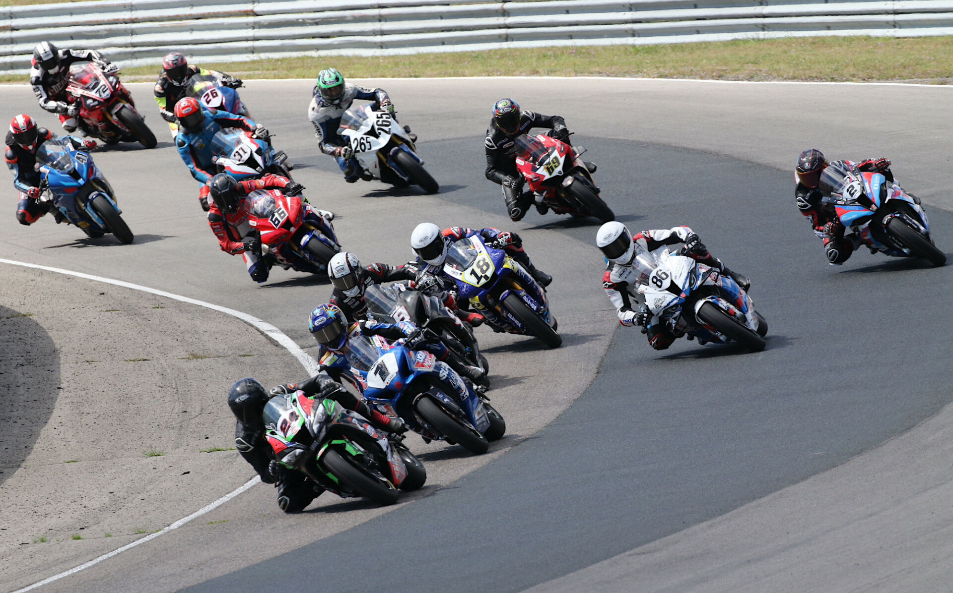 Sebastian Tremblay (24) leads Alex Dumas (1), Trevor Daley (9), Ben Young (86), Tomas Casas (18), and the rest of the feature GP Bikes Pro Superbike field in Race One action from Canadian Tire Motorsport Park in 2022. Photo by Rob O'Brien, courtesy CSBK.