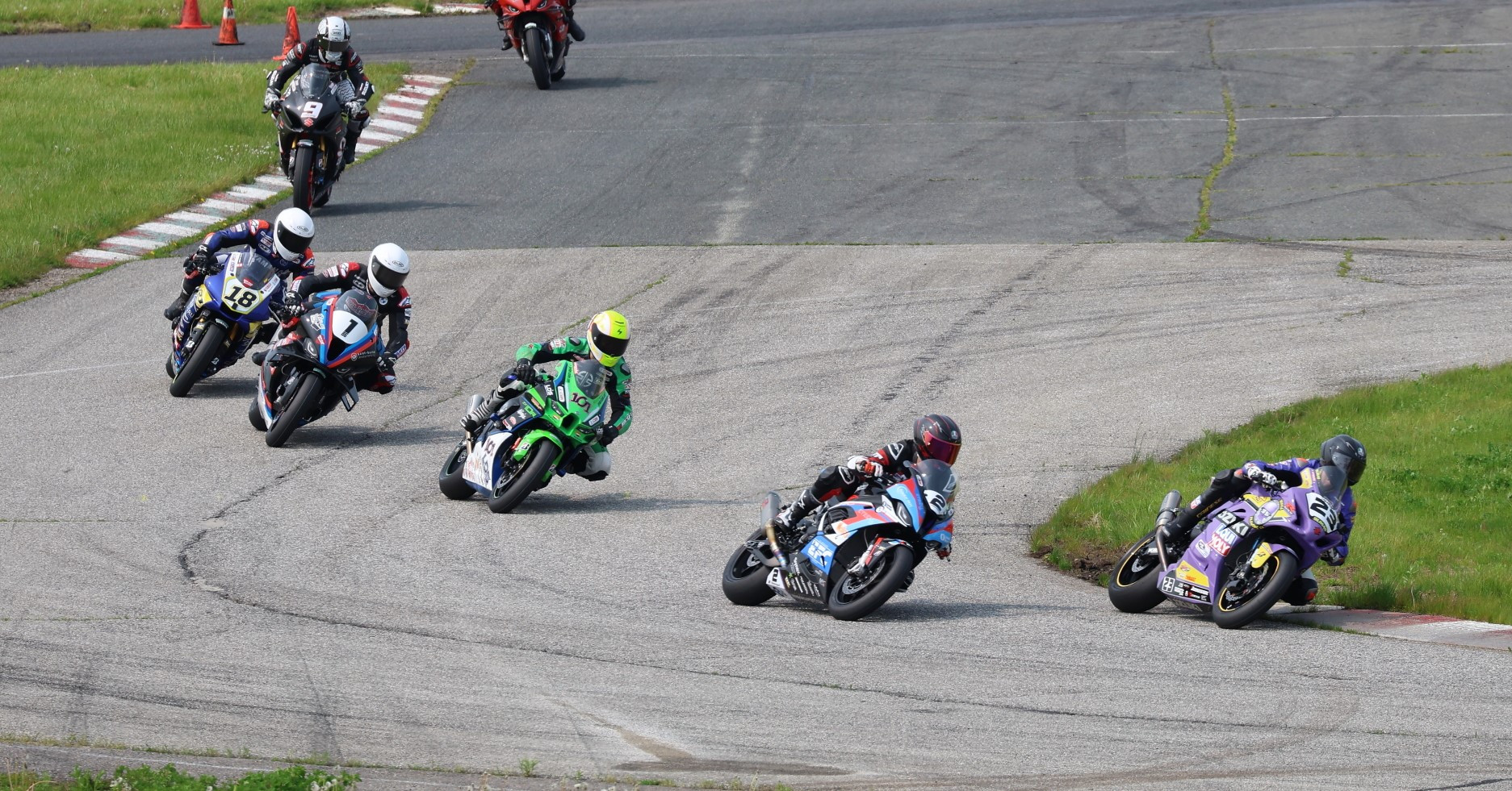 First lap Superbike action from Race Two Sunday at SMP with race winner Alex Dumas (23) leading over Sam Guerin (2), Jordan Szoke (101), Ben Young (1), Tomas Casas (18), Trevor Daley (9), and the rest. Photo by Rob O'Brien, courtesy CSBK.