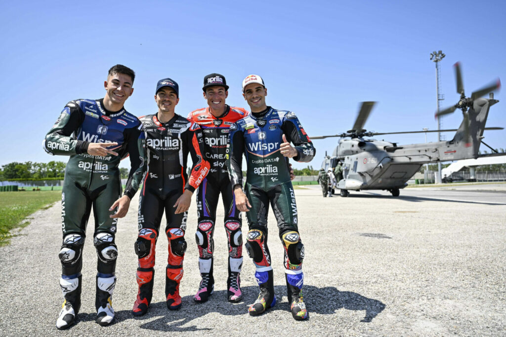 Aprilia MotoGP racers (from left) Raul Fernandez, Maverick Vinales, Aleix Espargaro, and Miguel Oliveira and Italian Navy helicopters participated in the event. Photo courtesy Aprilia.