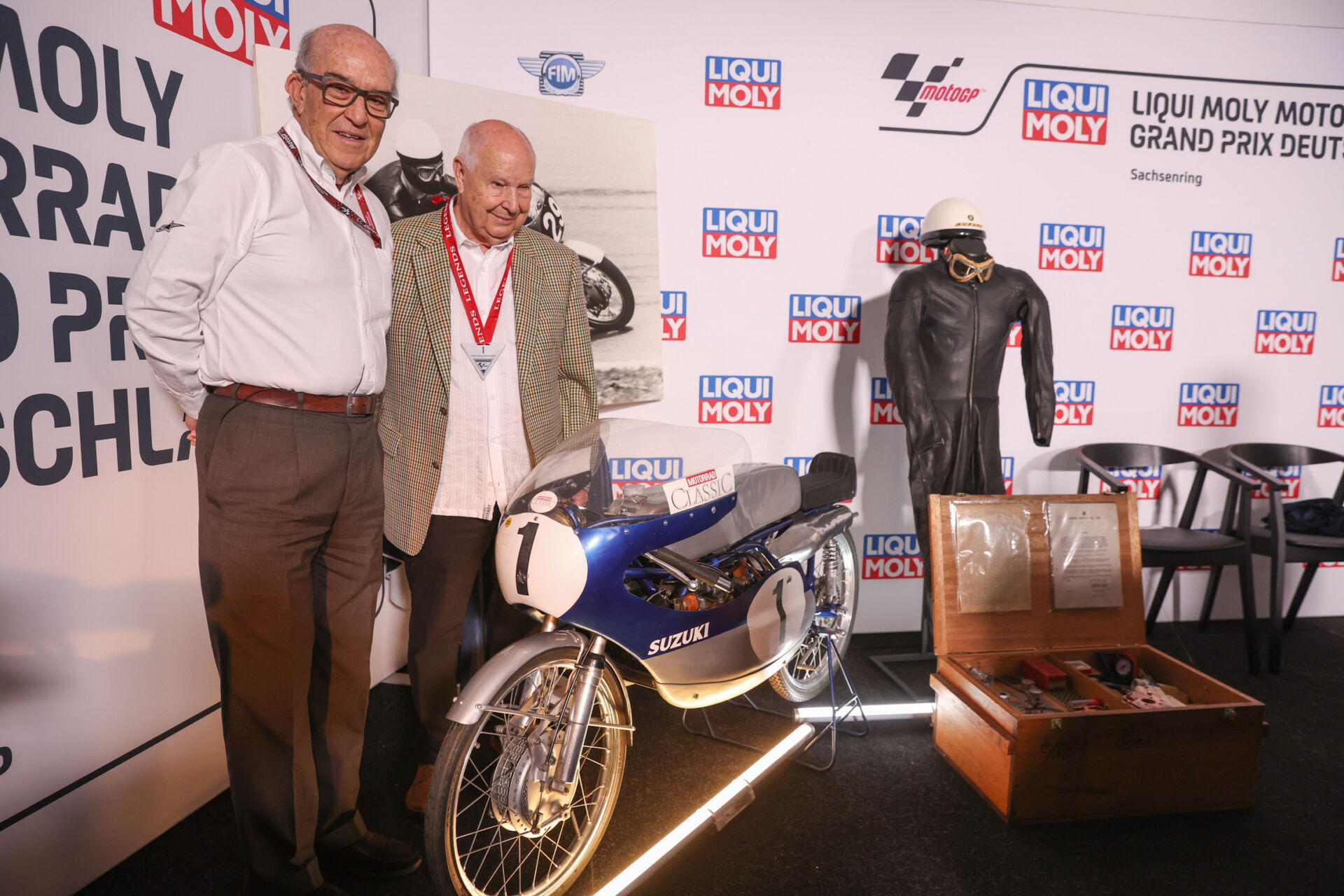 Hans-Georg Anscheidt (right) with Dorna CEO Carmelo Ezpeleta (left) and Anscheidt's World Championship winning Suzuki. Photo courtesy Dorna.