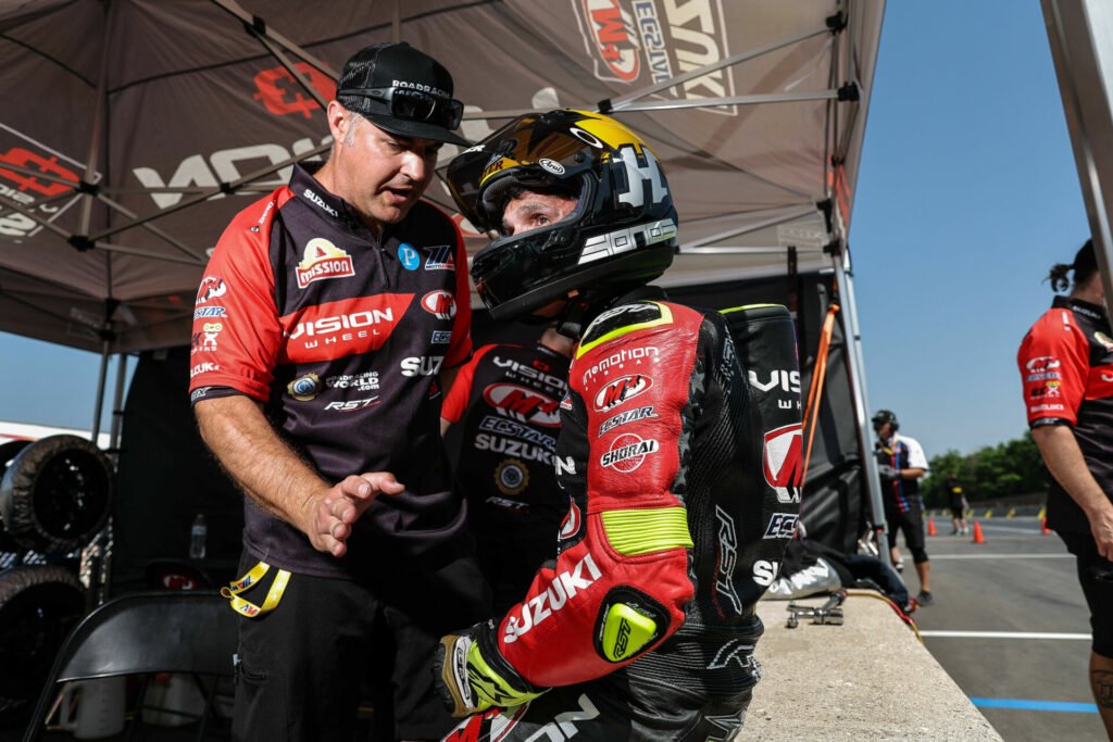 Team Hammer Vice-President of Operations Chris Ulrich (left) working with Toni Elias (right) in the pits at Road America. Photo by Brian J. Nelson.