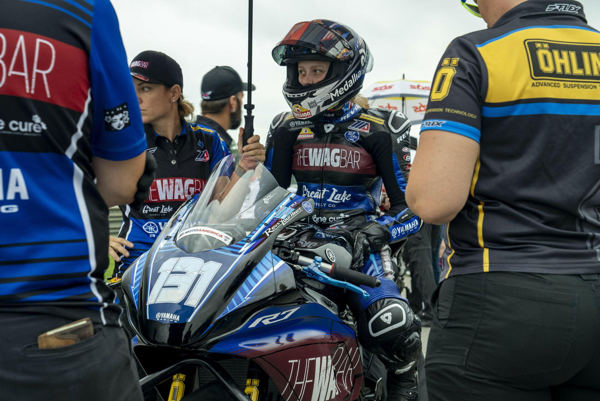 Follow MP13 Racing, Team Owner Melissa Paris, and young riders Aiden Sneed and Kayla Yaakov as they take on the 2023 MotoAmerica motorcycle racing season. In Episode Four, MP13 Racing welcomes Kayla back from injury for her career-first MotoAmerica Twins Cup races and Aiden Sneed continues to ride his Yamaha YZF-R3 against all the Kawasaki Ninja 400s in MotoAmerica Junior Cup, at Barber Motorsports Park.