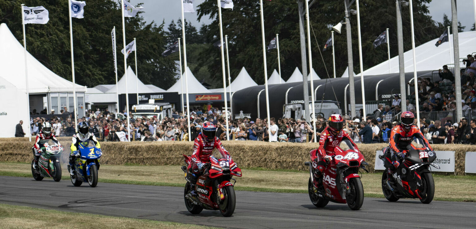 Lorenzo Savadori (32), Pol Espargaro (44), Michele Pirro (51), Kenny Lee Roberts (1), and Dakota Mamola (42) riding Alex Rins' LCR Honda on track at the Goodwood Festival of Speed. Photo courtesy Dorna.