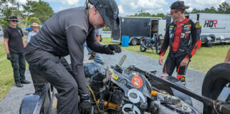 Army of Darkness Captain Sam Fleming pulls his crashed Yamaha YZF-R1 off the crash truck's trailer the day before the N2/WERA National Endurance four-hour race at Roebling Road Raceway. Team rider Hunter Dunhaam (right) and Crew Chief Tim Gooding (far left) stand by to help. Photo courtesy Army of Darkness.