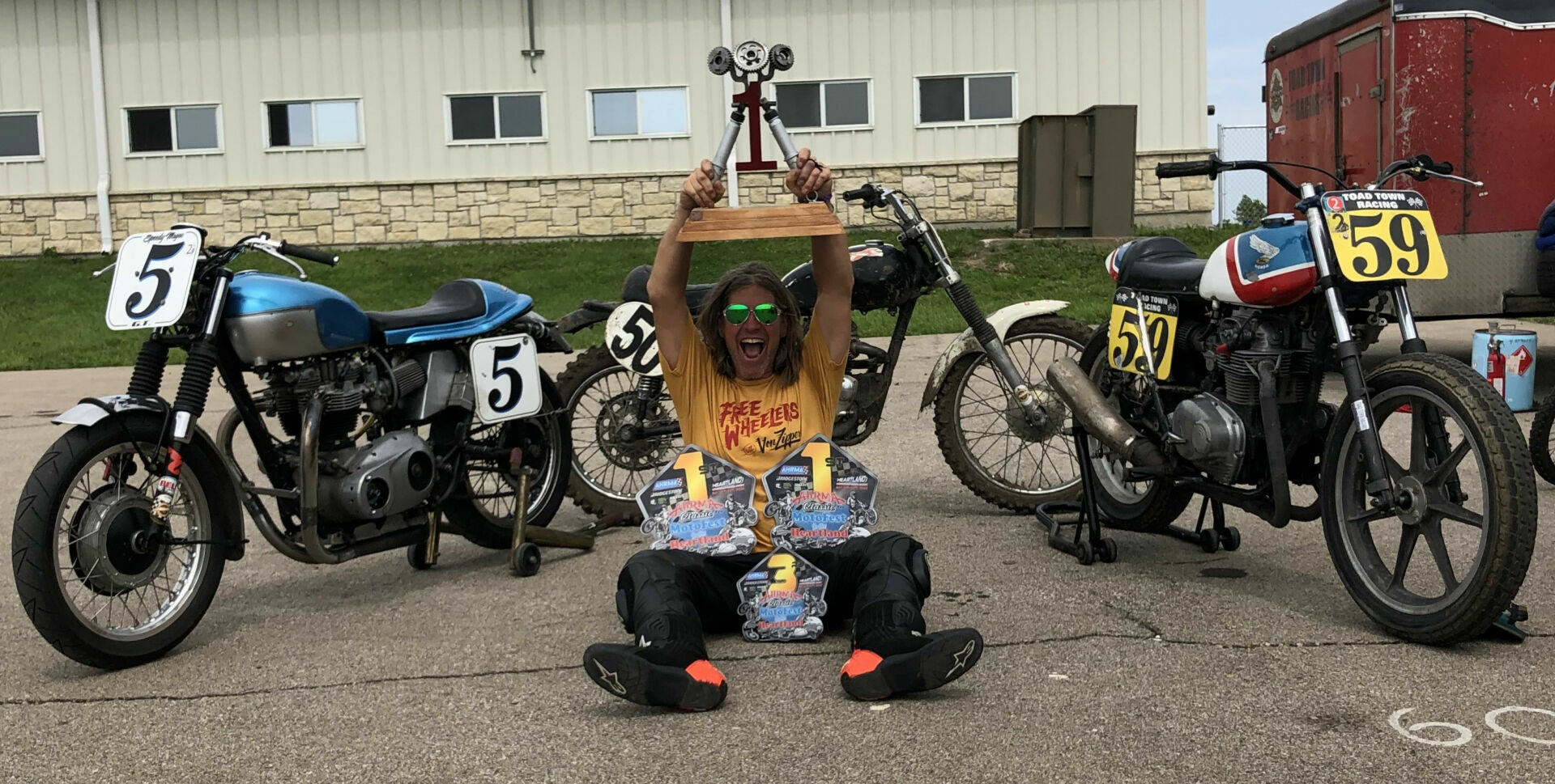 Greg Tomlinson, winner of the 2022 AHRMA Classic MotoFest™ in the Heartland Triple Crown, with his (from left) road race, motocross, and flat track bikes. Photo by Stephanie Vetterly, courtesy AHRMA.
