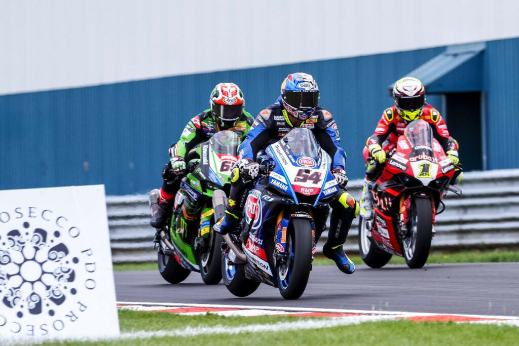 Toprak Razgatlioglu (54), Jonathan Rea (65), and Alvaro Bautista (1) race for position in England. Photo courtesy Dorna.