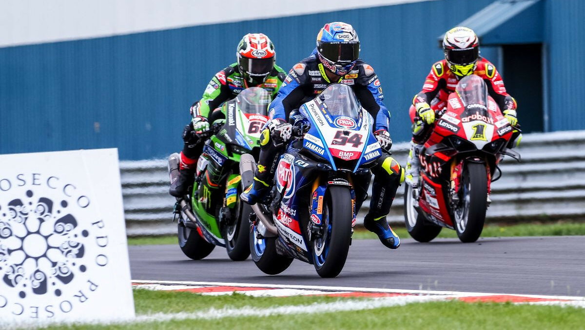 Toprak Razgatlioglu (54), Jonathan Rea (65), and Alvaro Bautista (1) race for position in England. Photo courtesy Dorna.