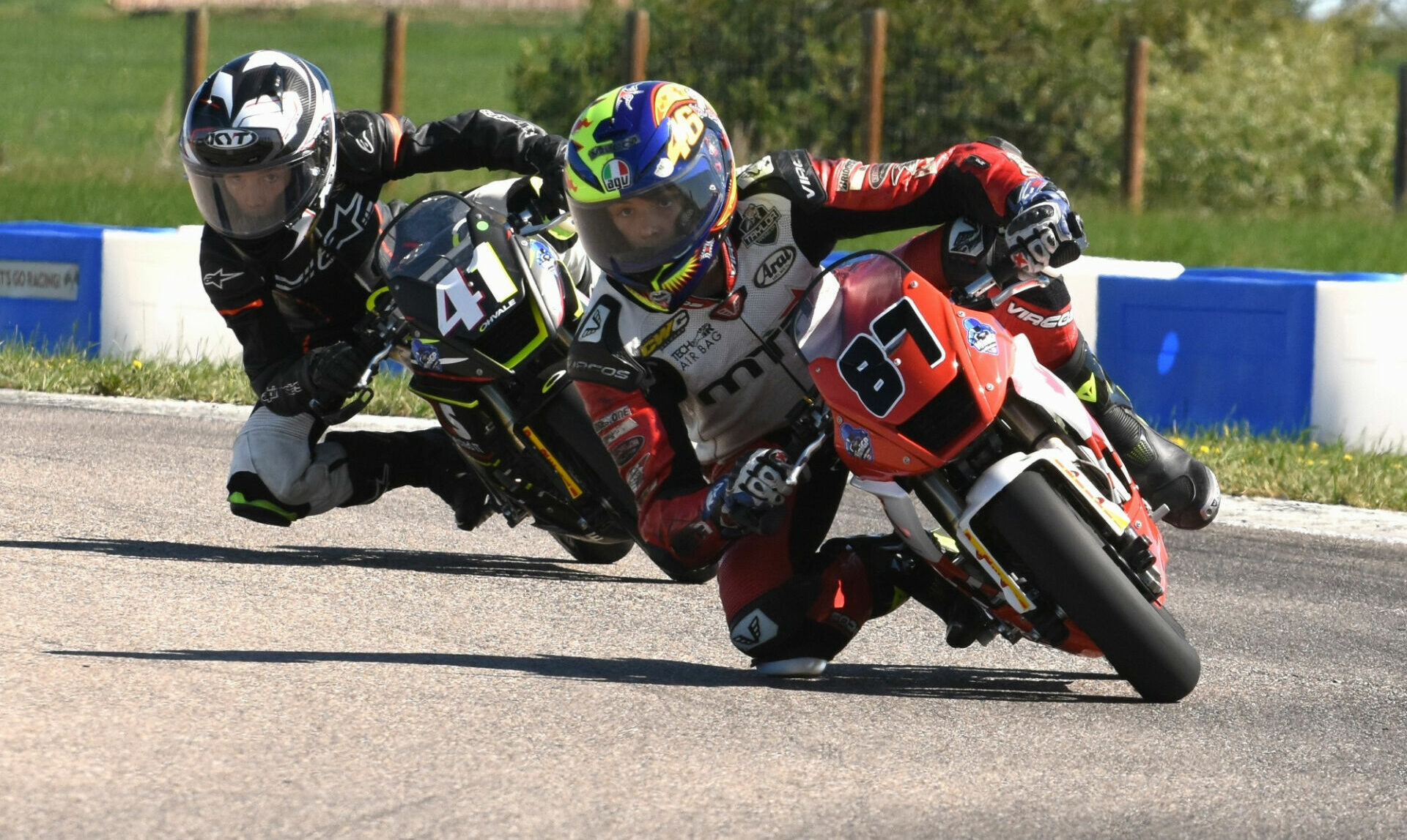 Rhys McNutt (87) and 41 Lincoln Scott (41) race for position during an FIM MiniGP Canada event at Greg Moore Raceway, in British Columbia, Canada. Photo by Colin Fraser.