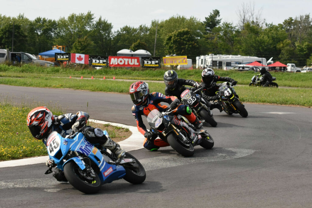 Ashton Parker (45) pulled off a stunning turn one move to beat Ben Hardwick (43), Michael Galvis (83), and Lincoln Scott (41) for his first career victory in race three on Sunday. Photo by Jeremy Fleming, courtesy FIM MiniGP Canada.