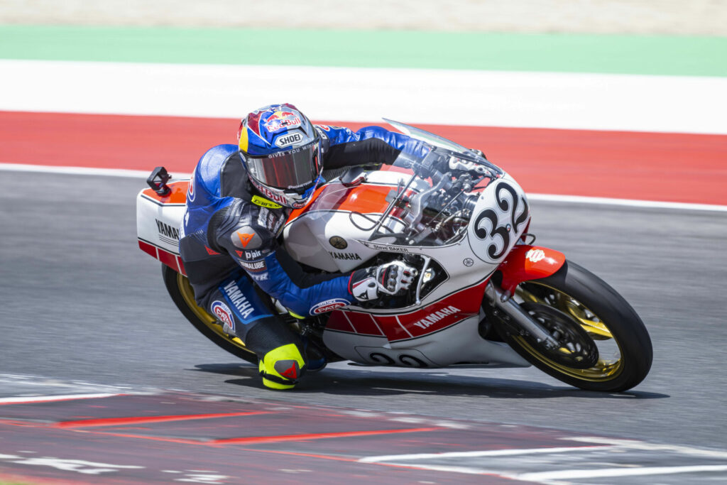 Toprak Razgatioglu (32) sampling a replica of Steve Baker's 1977 FIM Formula 750 World Championship-winning Yamaha YZR750 0W31. Photo courtesy Yamaha.