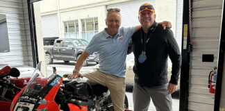 Leslie Stretch (right) hangs out at WeatherTech Laguna Seca with 1993 500cc World Champion Kevin Schwantz (left), who is sitting on a MotoAmerica Superbike formerly ridden by Danilo Petrucci for Warhorse HSBK Racing Ducati. Life is good for Stretch, who is helping make it safer for racers across the U.S. Photo courtesy Leslie Stretch.