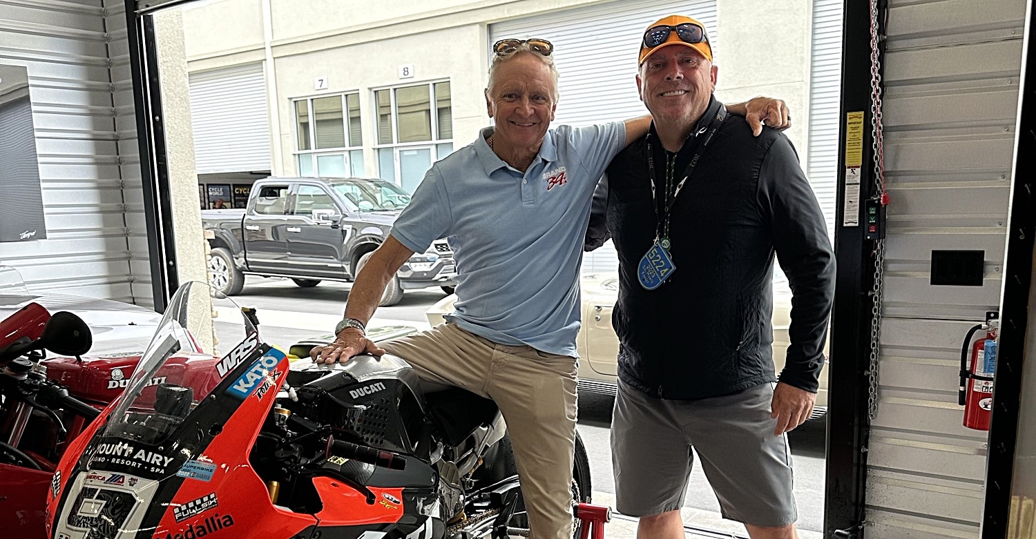 Leslie Stretch (right) hangs out at WeatherTech Laguna Seca with 1993 500cc World Champion Kevin Schwantz (left), who is sitting on a MotoAmerica Superbike formerly ridden by Danilo Petrucci for Warhorse HSBK Racing Ducati. Life is good for Stretch, who is helping make it safer for racers across the U.S. Photo courtesy Leslie Stretch.