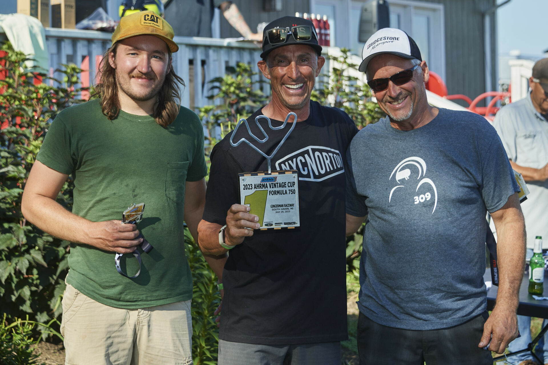 The Vintage Cup podium finishers from both races at Gingerman Raceway: winner Shane Turpin (center), runner-up Tim Joyce (right), and third-place finisher Colton Roberts. Photo by Bill Griffin, courtesy AHRMA.