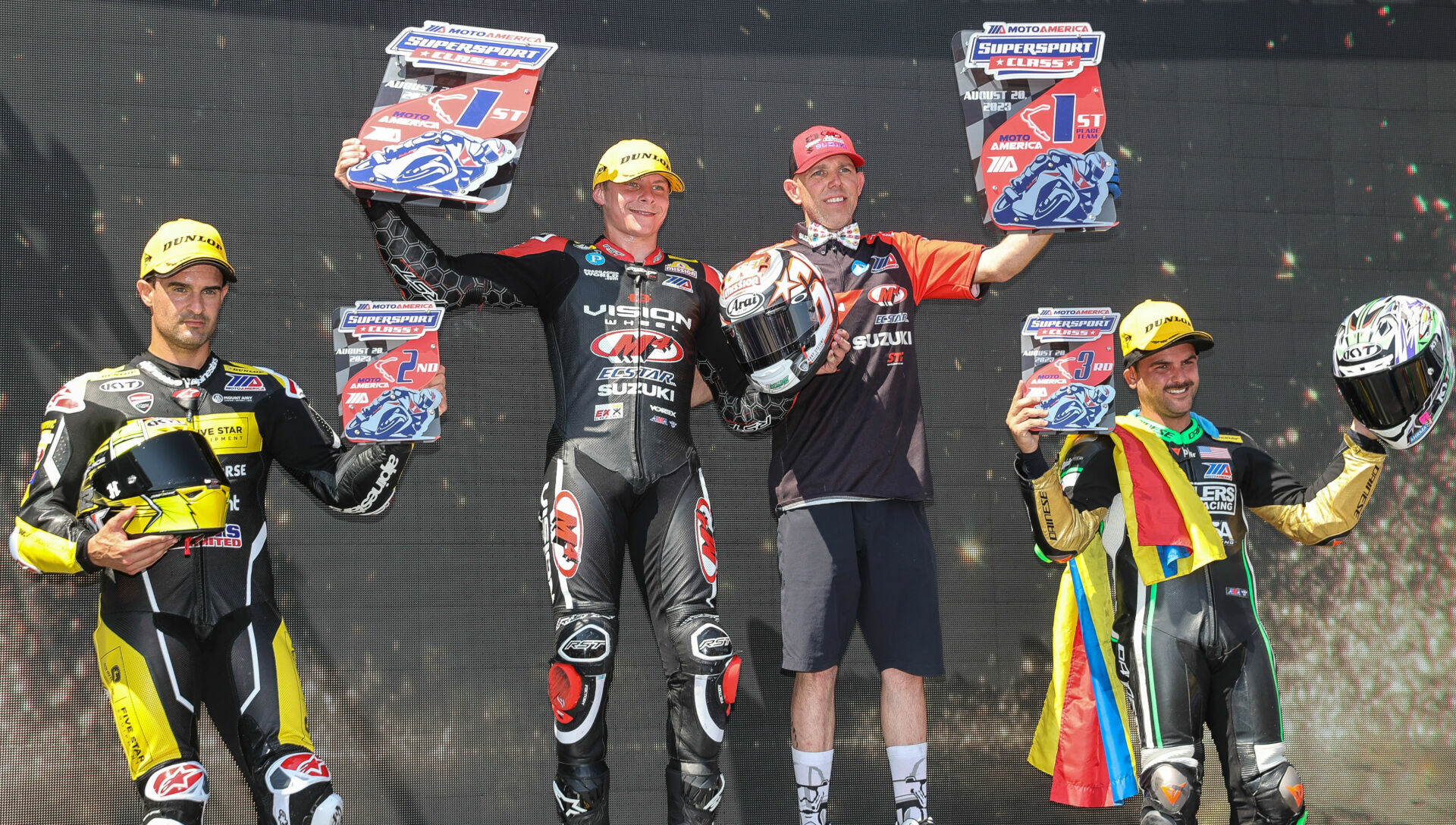 Tyler Scott (second from left) stands atop the podium with mechanic Dustin Cyr (second from right) after winning Supersport Race Two over runner-up Xavi Fores (far left) and third-place finisher Stefano Mesa (far right). Photo by Brian J. Nelson, courtesy Suzuki Motor USA, LLC.