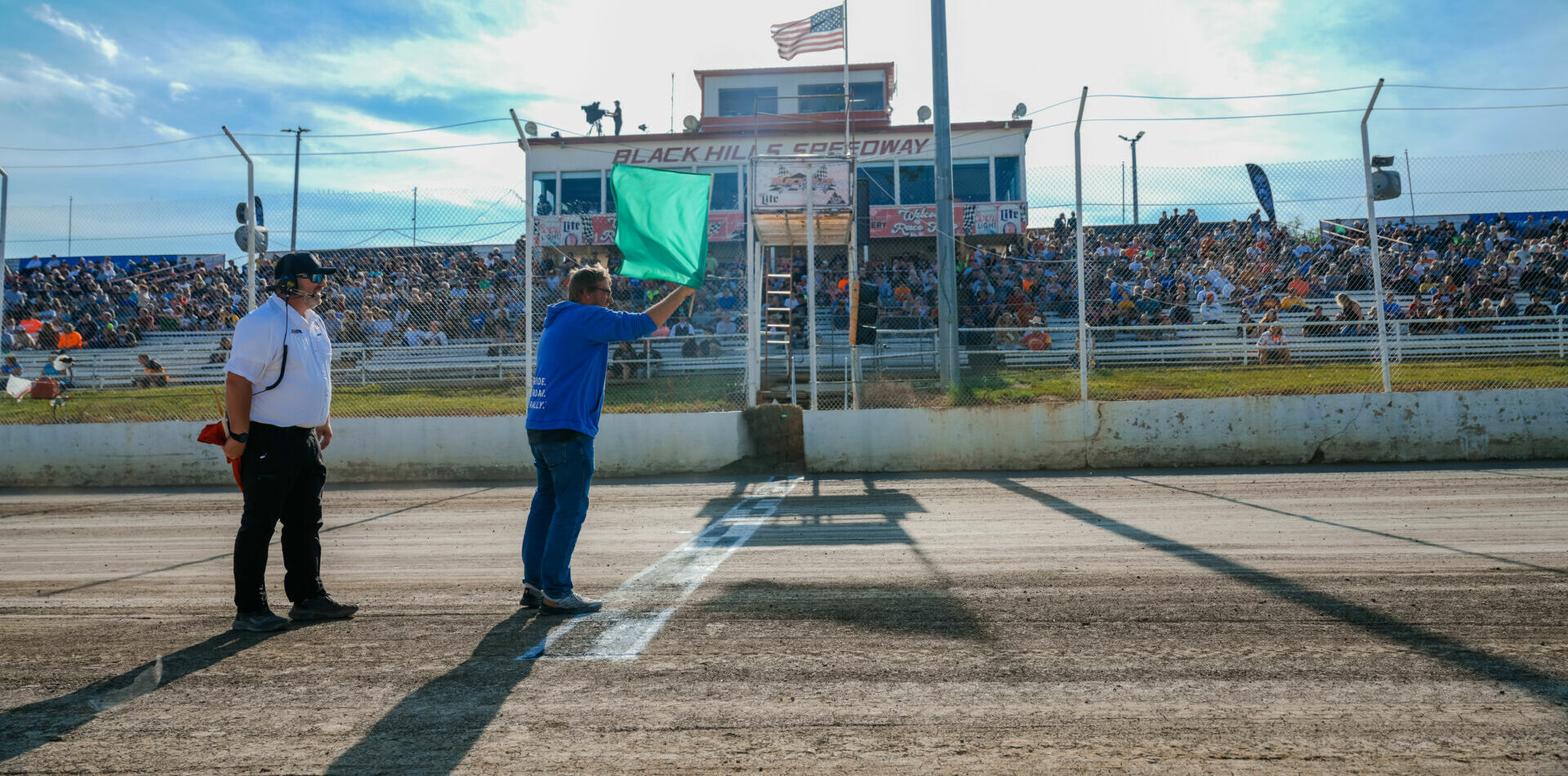 The green flag being waved at the American Flat Track (AFT) Black Hills Half-Mile, in South Dakota. Photo by Kristen Lassen, courtesy AFT.