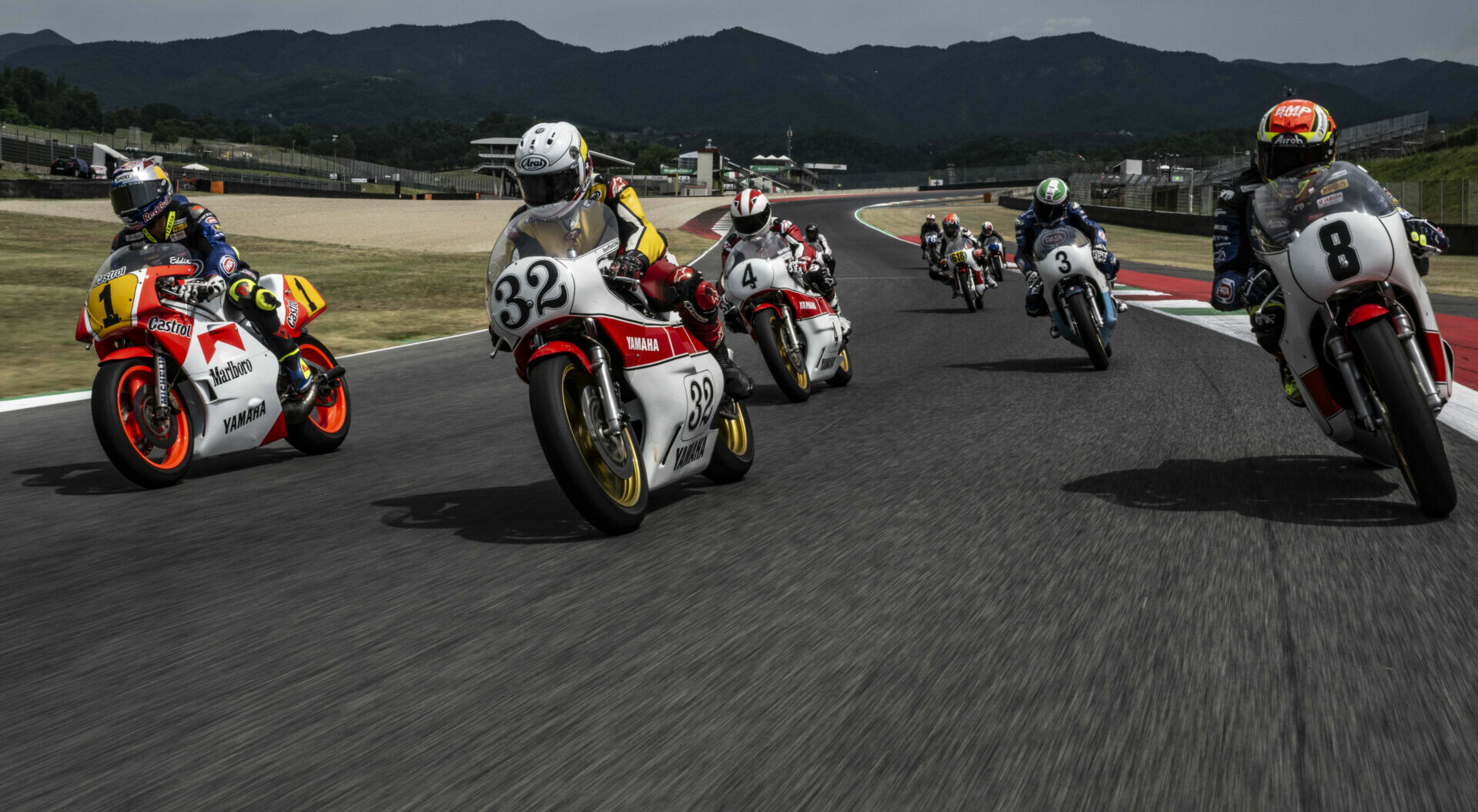 Toprak Razgatlioglu (1), Carlos Lavado (32), Johnny Cecotto (4), Andrea Locatelli (8), and others on vintage Yamaha racebikes at Mugello. Photo courtesy Yamaha.