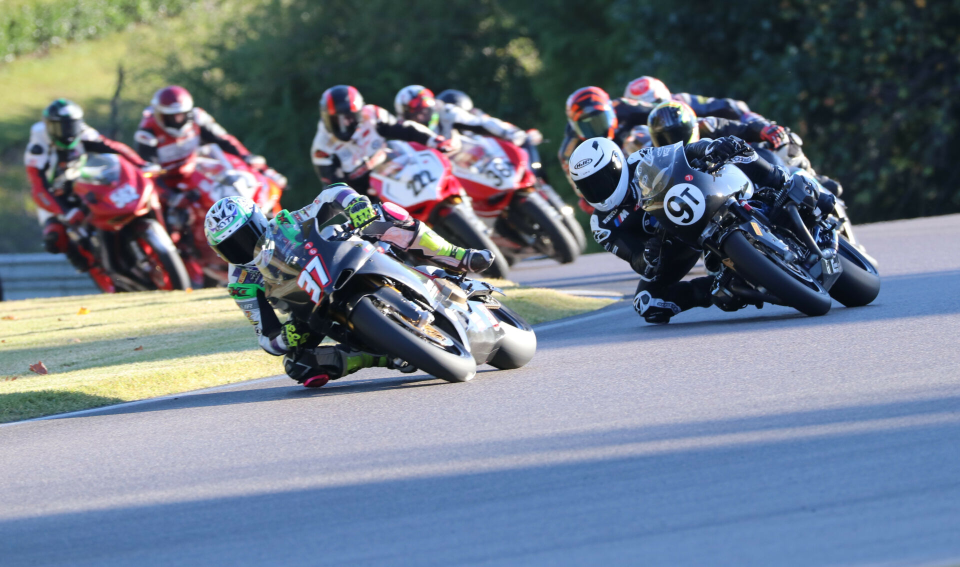 Action from the 2022 4SR Pro Challenge with Stefano Mesa (37) leading Nate Kern (9T), Jeff Graham (222), Arnold Hastings (38A), and the rest of the field. Photo by Craig Chawla, courtesy AHRMA.