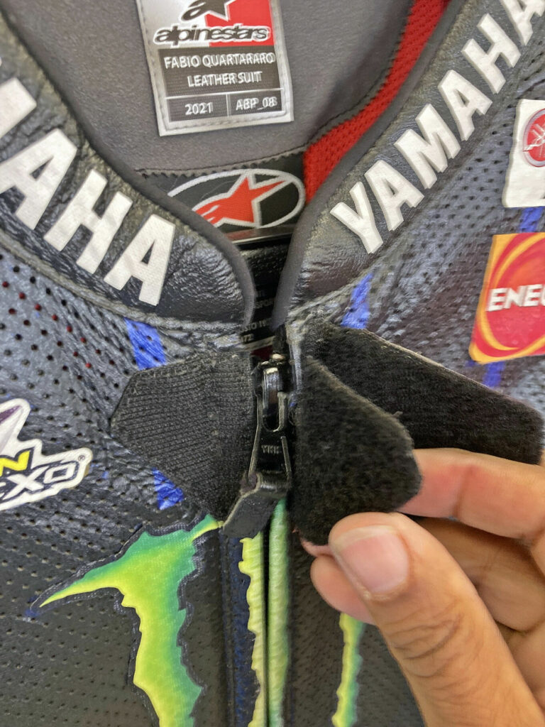 The middle flap on MotoGP World Champion Fabio Quartararo's zipper pull retention system closes underneath the tab once it is fully zipped, and then the tab sits in a V-shaped notch. Photo by Michael Gougis.