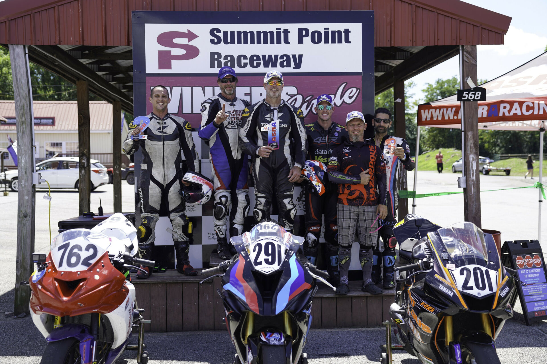 Overall winner Grease Monkey Racing's Eric Helmbach (second from left) and Steve Hoffman (third from left); runner-up Coleman Powersports' Brad Moser (far left); and third-place finisher Hazardous Racing's Jonathan Schweiger (third from right), RJ Wade (second from right), and Chet FinkBeiner (far right). Photo courtesy ASRA.