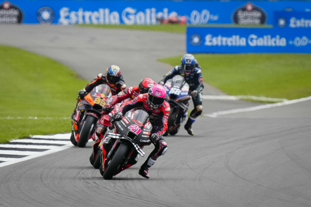 Aleix Espargaro (41) beat Francesco Bagnaia (behind Espargaro), Brad Binder (33), and Miguel Oliveira (88) to the checkered flag in the MotoGP race at Silverstone. Photo courtesy Dorna.