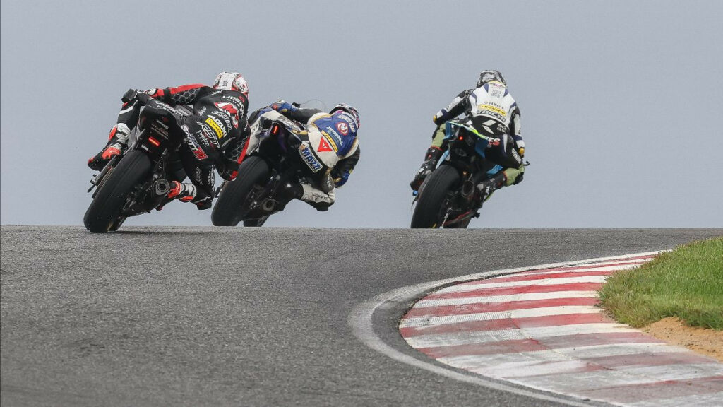 Josh Hayes (right) leads Anthony Mazziotto (center) and Tyler Scott (left) en route to victory in the Supersport race. Photo by Brian J. Nelson.