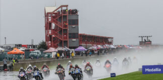 Jake Gagne (1), Josh Herrin (2), Mathew Scholtz (11), JD Beach (95) and the rest of the Medallia Superbike pack heads into a very wet turn one at New Jersey Motorsports Park on Saturday. Photo by Brian J. Nelson.