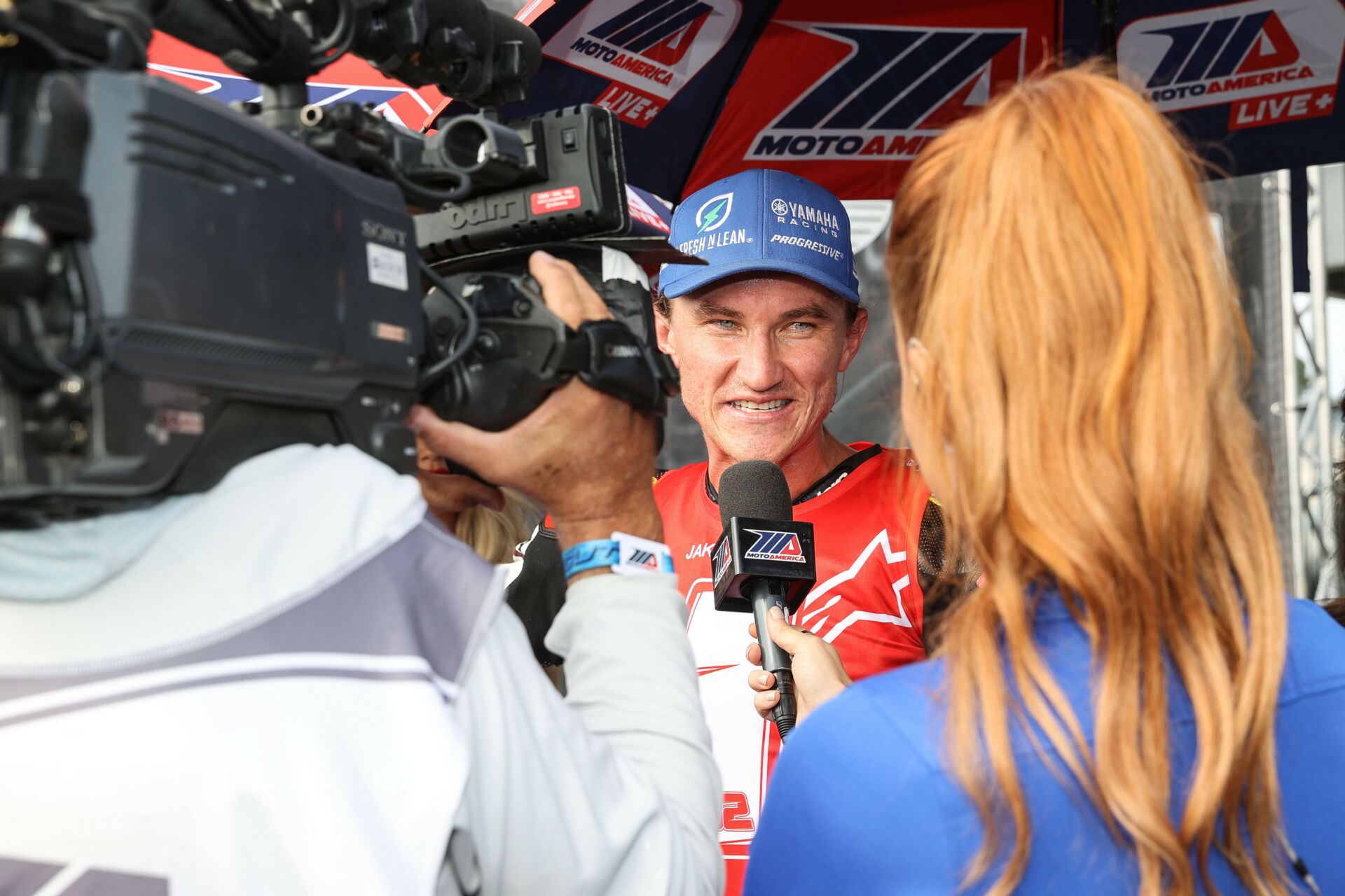 Jake Gagne being interviewed in 2022 by Hannah Lopa, part of MotoAmerica's in-house TV production team. Photo by Brian J. Nelson.