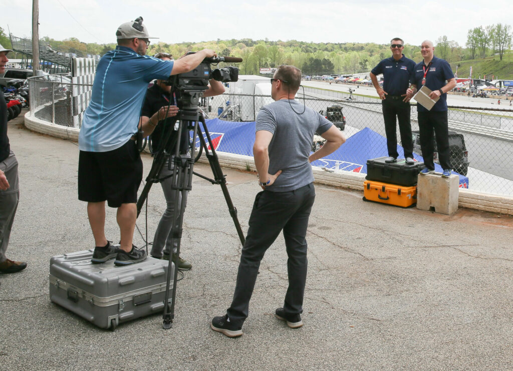 On-air commentators Jason Pridmore (left) and Greg White (right) shooting a segment for beIN Sports' coverage of MotoAmerica in 2018. Photo by David Swarts.