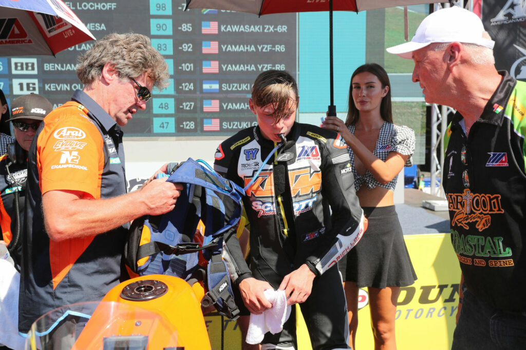 Tyler Scott (center) drinks from a fluid bladder following a MotoAmerica Junior Cup race at Ridge Motorsports Park in 2021. Photo by Brian J. Nelson.