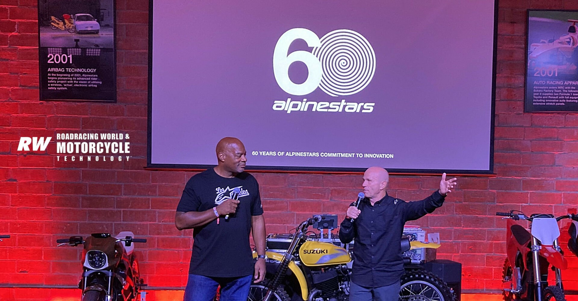 Comedian and actor Alonzo Bodden (left) and MotoGP Legend Randy Mamola (right) were the masters of ceremonies for the Alpinestars 60th anniversary celebration in downtown Los Angeles. Note the poster in the upper left corner, which commemorates the beginning of the company's work on inflatable rider protection. Airbags now are required protective gear at the international racing level. Photo by Michael Gougis.