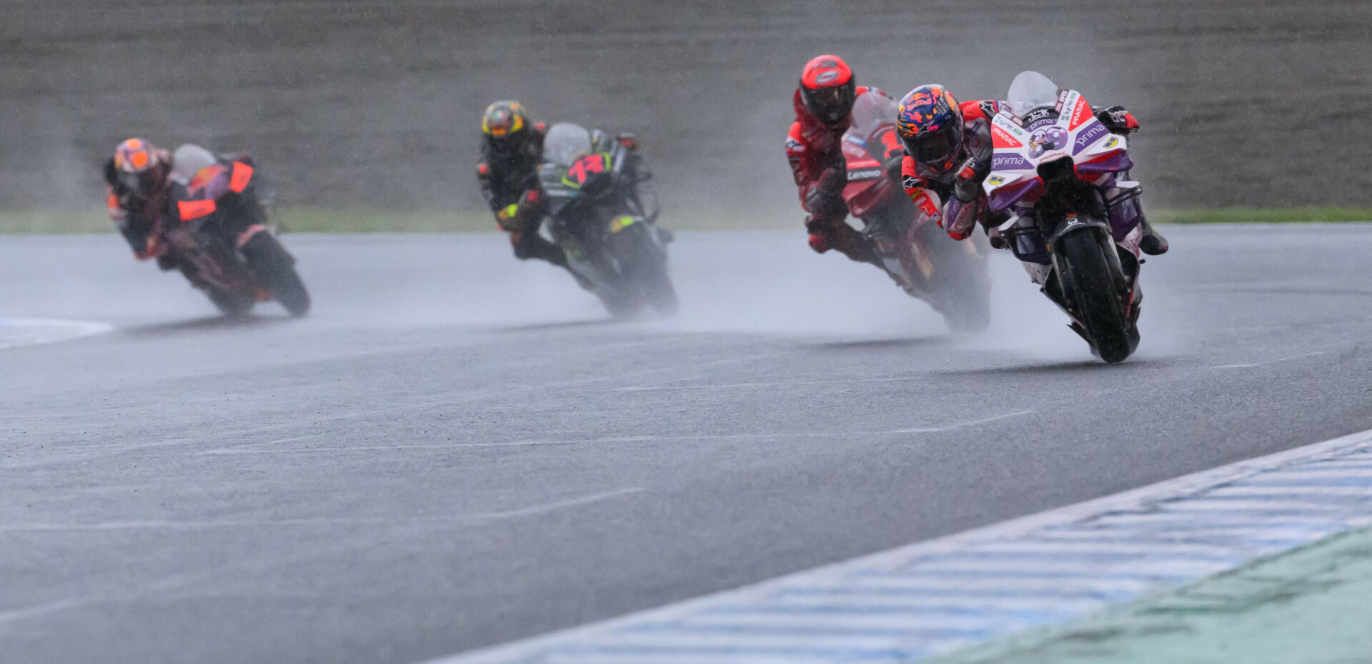 Jorge Martin (89) leads Francesco Bagnaia (1), Marco Bezzecchi (72), and Jack Miller (43) in the very wet Japanese Grand Prix at Motegi. Photo by Kohei Hirota.