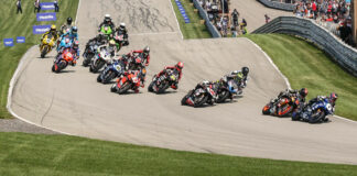 Jake Gagne (1) leads Mathew Scholtz (11), Bobby Fong (50), PJ Jacobsen (99), Cameron Beaubier (behind Jacobsen), Richie Escalante (54), Josh Herrin (2), and the rest into Turn One at Pittsburgh International Race Complex. Photo by Brian J. Nelson.