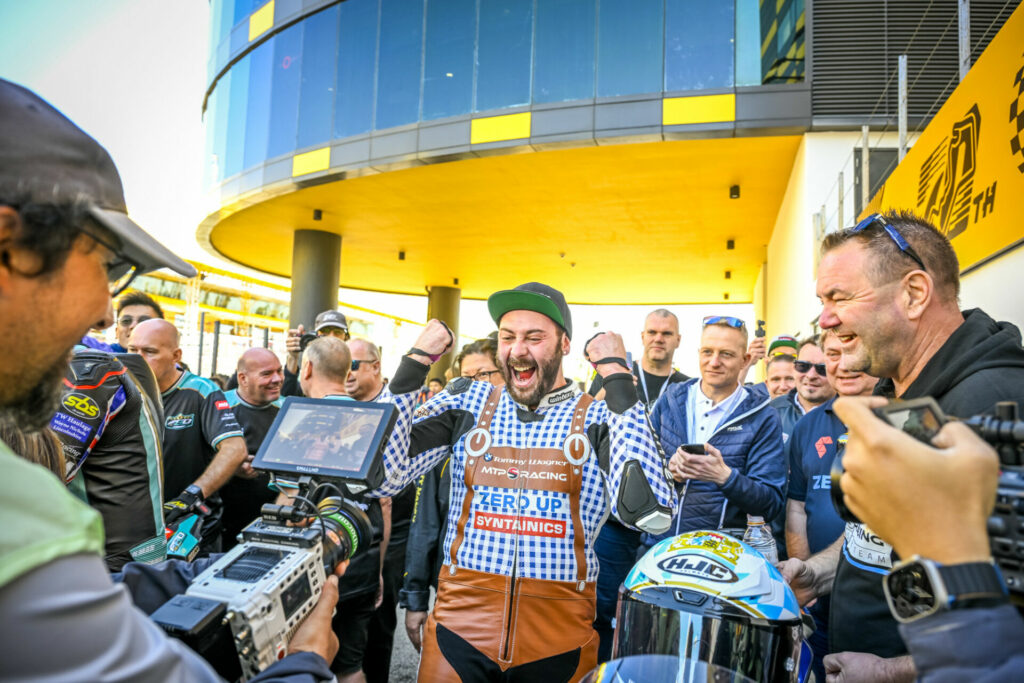 David Datzer (center) celebrates his third-place finish in the Macau Motorcycle Grand Prix. Photo courtesy BMW Motorrad Motorsport and the Macau Grand Prix Committee.