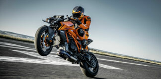 A 2024 KTM 1390 Super Duke R EVO at speed on a closed curse with a test rider. Photo by Rudi Schedl, courtesy KTM.