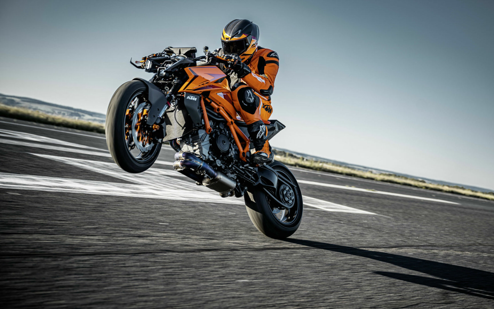 A 2024 KTM 1390 Super Duke R EVO at speed on a closed curse with a test rider. Photo by Rudi Schedl, courtesy KTM.