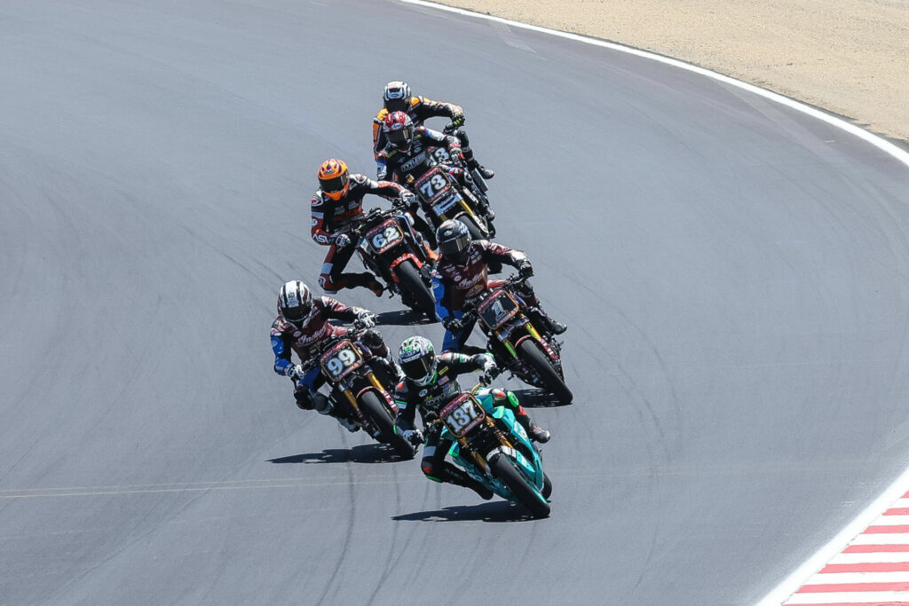 Stefano Mesa (137), riding his electric Energica Eva Ribellle RS, leads Jeremy McWilliams (99), Tyler O'Hara (1), Andy DiBrino (62), Larry Pegram (73), and Cory West (behind Pegram) during a MotoAmerica Mission Super Hooligan race at Laguna Seca. Photo courtesy Energica.