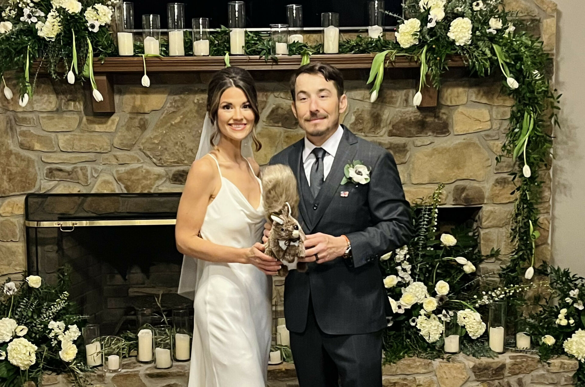 Newlyweds Roger Hayden and Elizabeth Ebelhar. The squirrel they are holding is a tribute to Hayden's late father Earl 