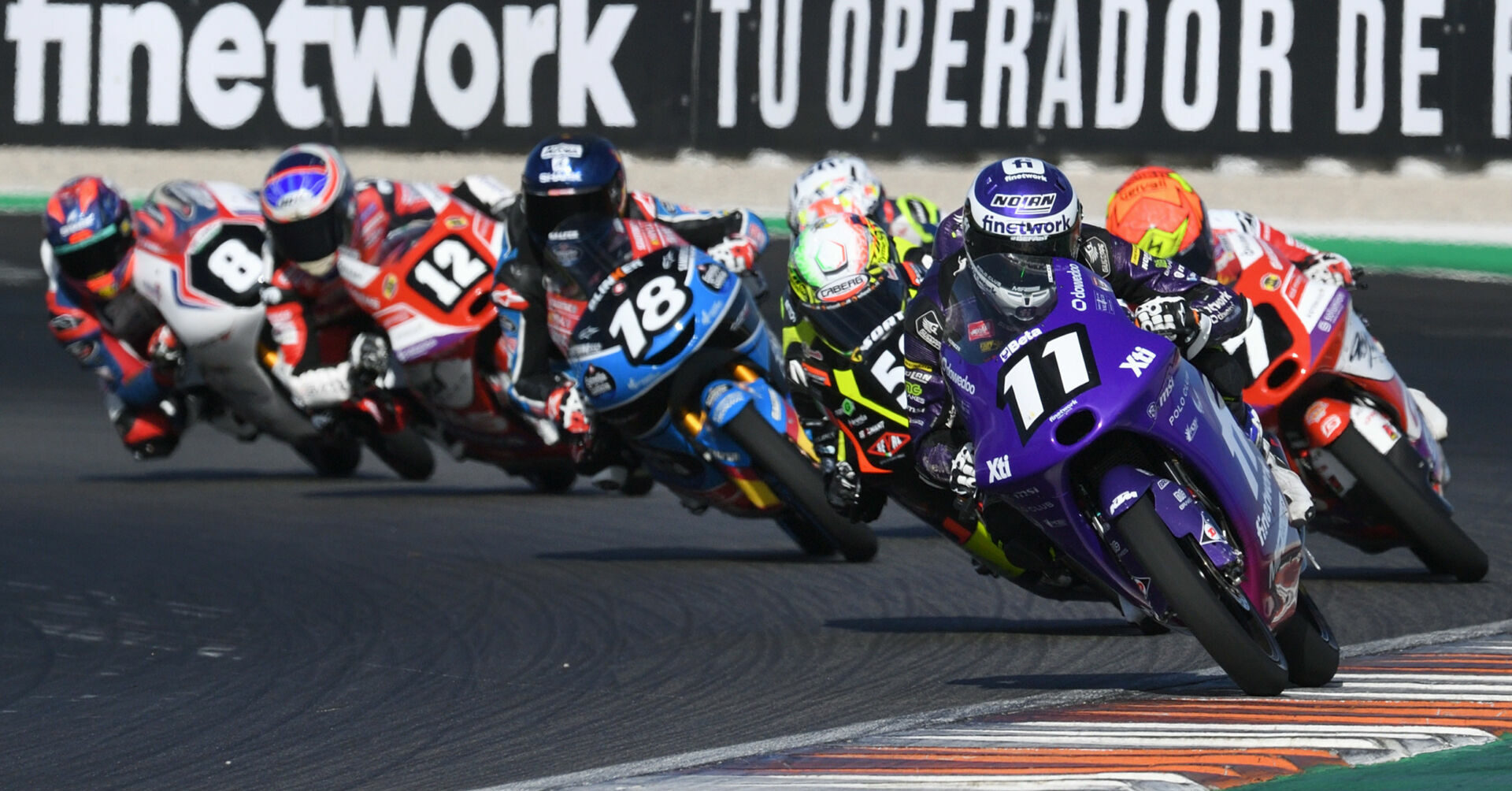 Adrian Cruces (11) leads JuniorGP World Championship Race One at Valencia. Photo courtesy Dorna.