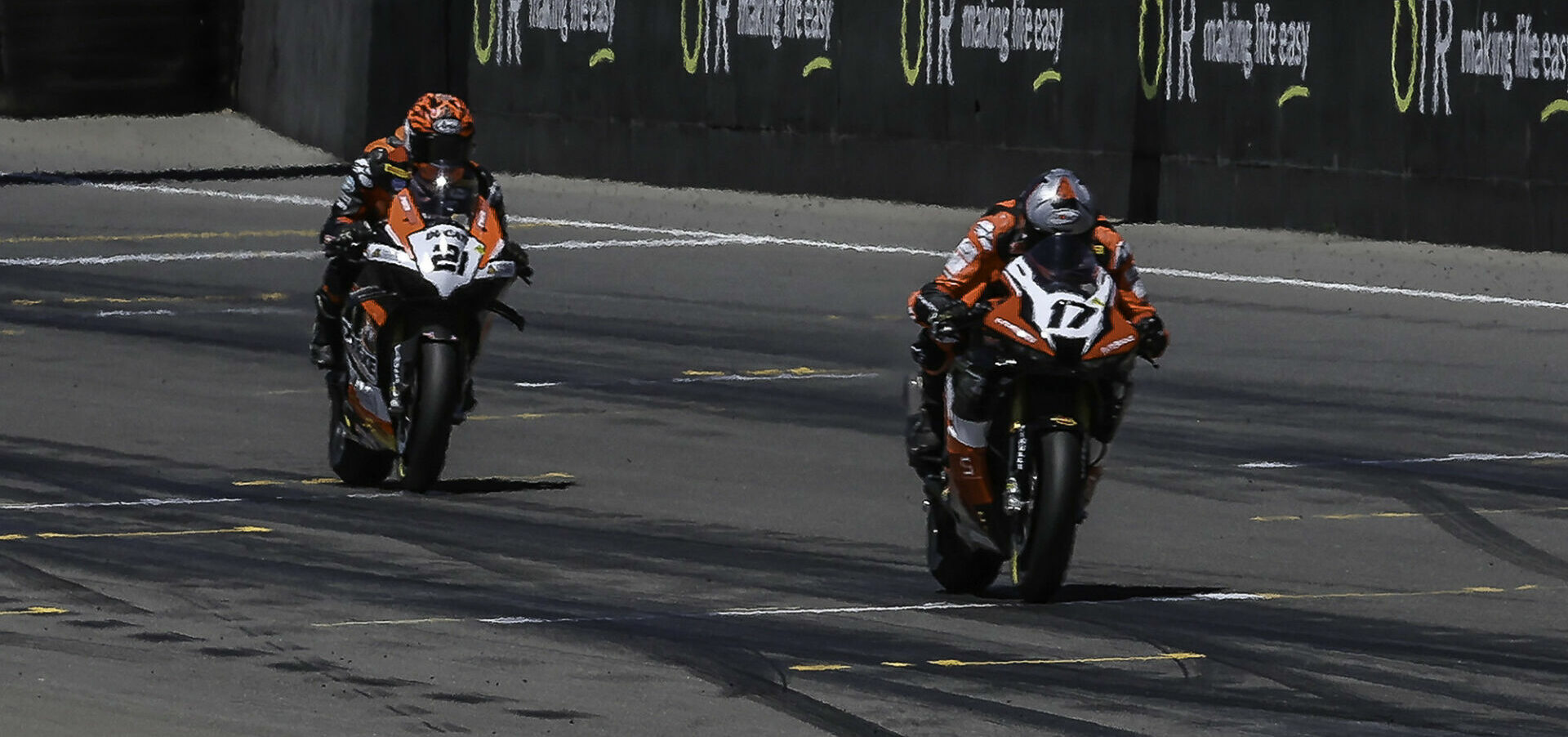 Troy Herfoss (17) leads Josh Waters (21) across the finish line at the end of Race One. Photo courtesy ASBK.