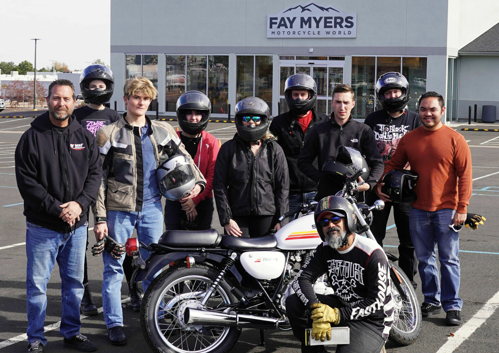 Ride On President Jim Wilson (far left) and Coach Faisal Mustafa (kneeling) with Basic Rider Course students. Photo courtesy Ride On.