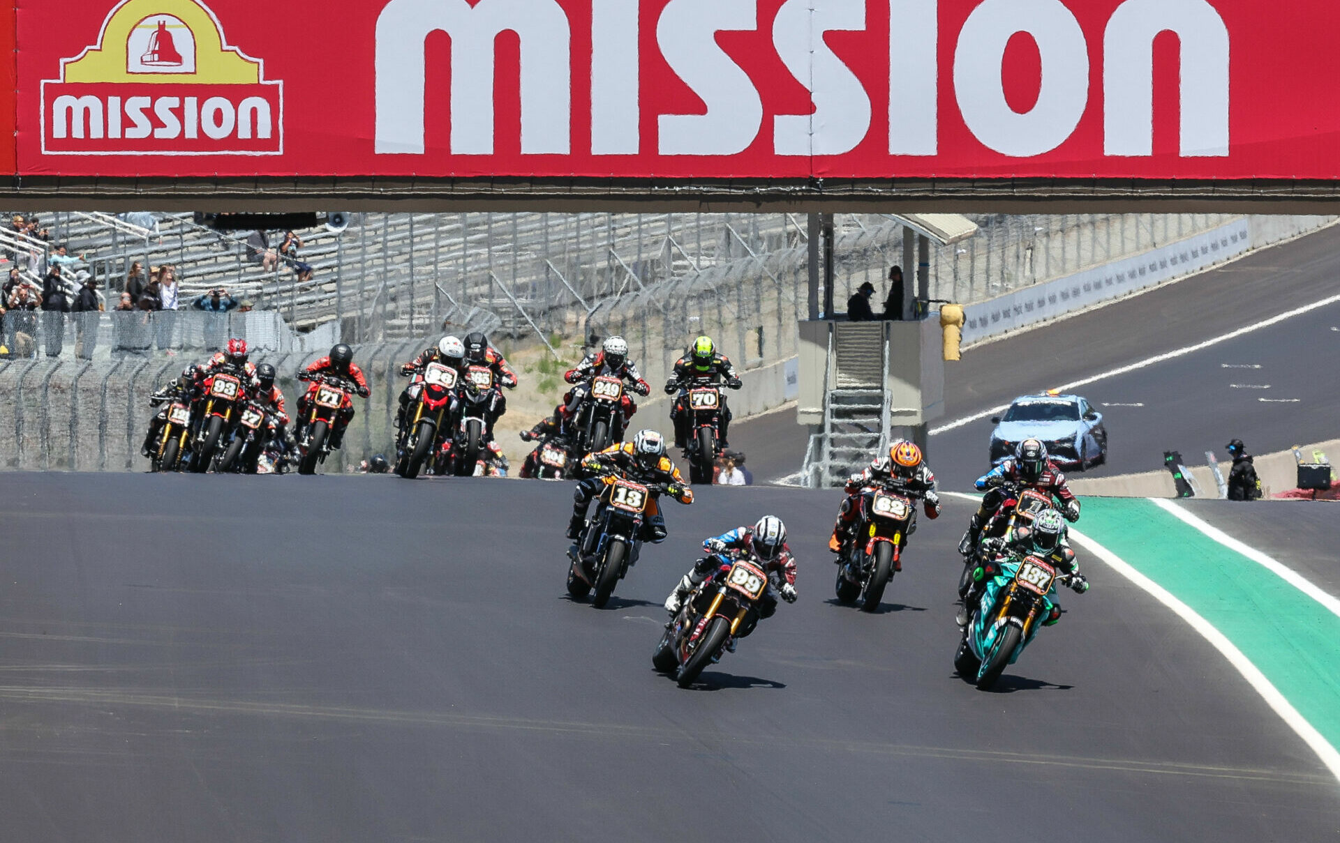 Jeremy McWilliams (99) and Stefano Mesa (137) lead the Mission Super Hooligan National Championship Race Two start over Turn One at Laguna Seca. Photo by Brian J. Nelson.