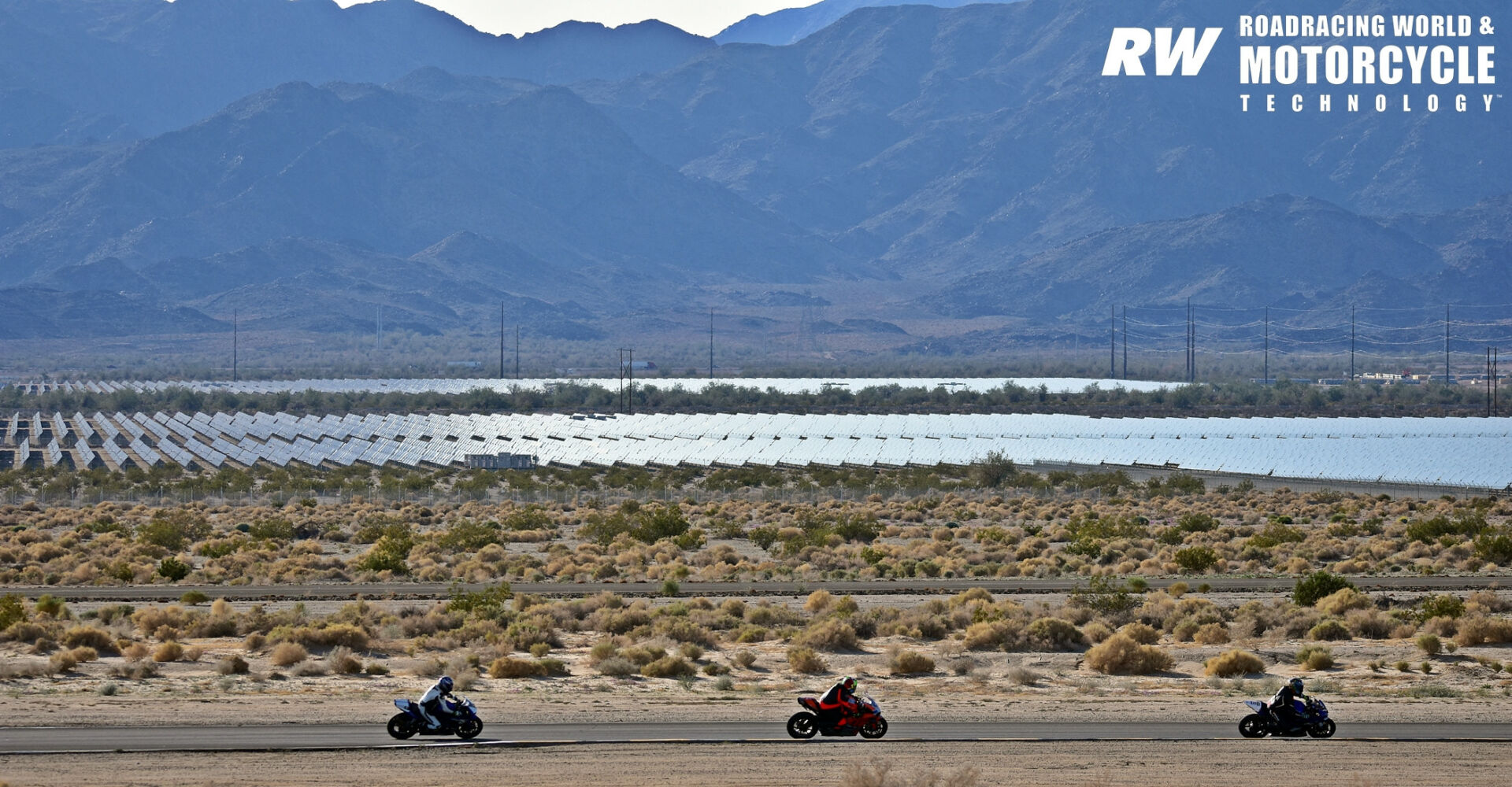 Riders at a track day at Chuckwalla Valley Raceway against a backdrop of a vast array of solar panels. With solar power generation on the rise, these land uses are compatible with racetracks and can protect them from the encroachment of developments that are not friendly to circuits. Photo by Michael Gougis.