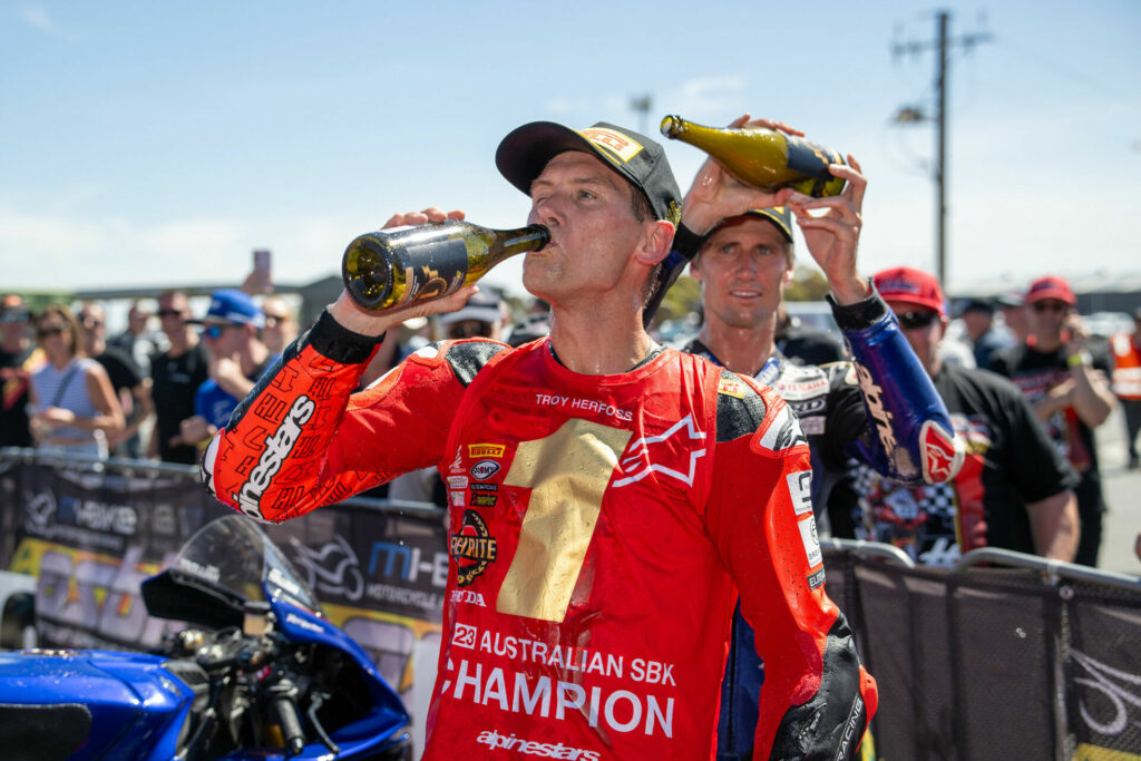 A jubilant Troy Herfoss (left) flanked by outgoing champion, Mike Jones (right). Photo by RB Moto Lens, courtesy ASBK.