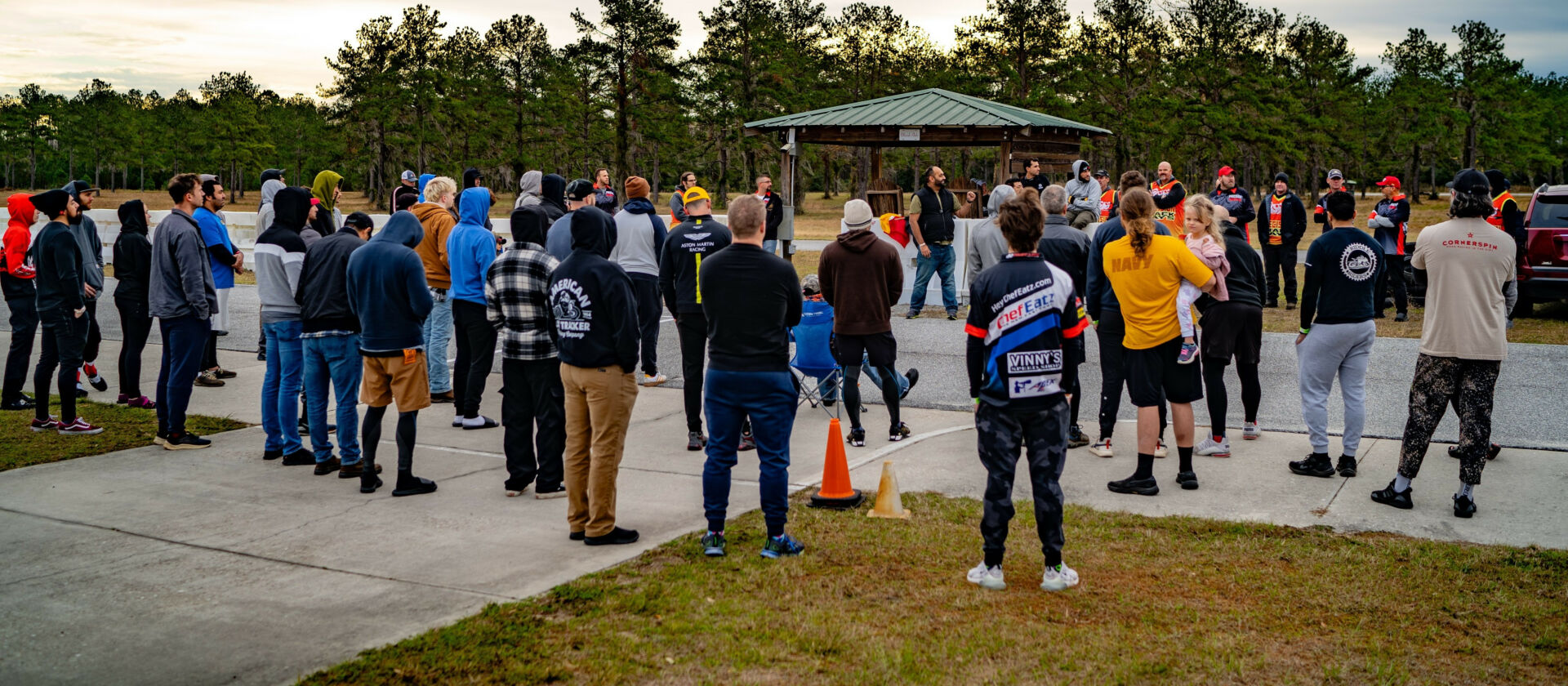 The rider's meeting at Precision Track Days' first-ever event, at Jennings GP in December 2023. Co-owner Fahad Khan (wearing a black vest near the corner worker shelter) is addressing the group. Photo courtesy Precision Track Days.