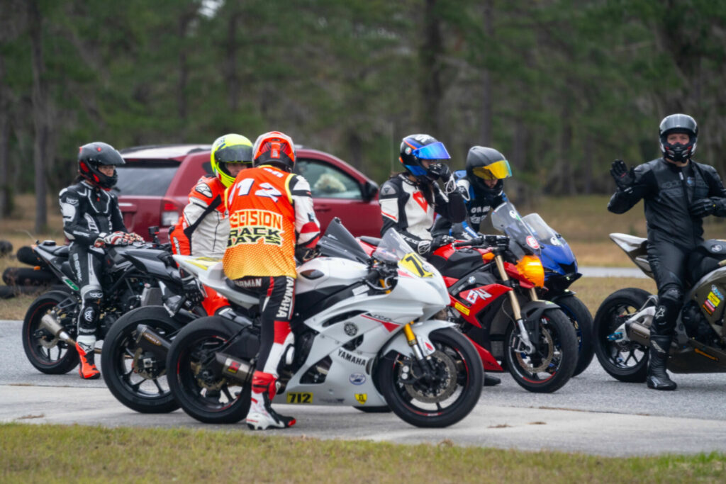 Instructor Jeremy Jarman (wearing a jersey, back to the camera) talks to new Intermediate riders before the start of their session to ensure they have a plan. Photo courtesy Precision Track Days.