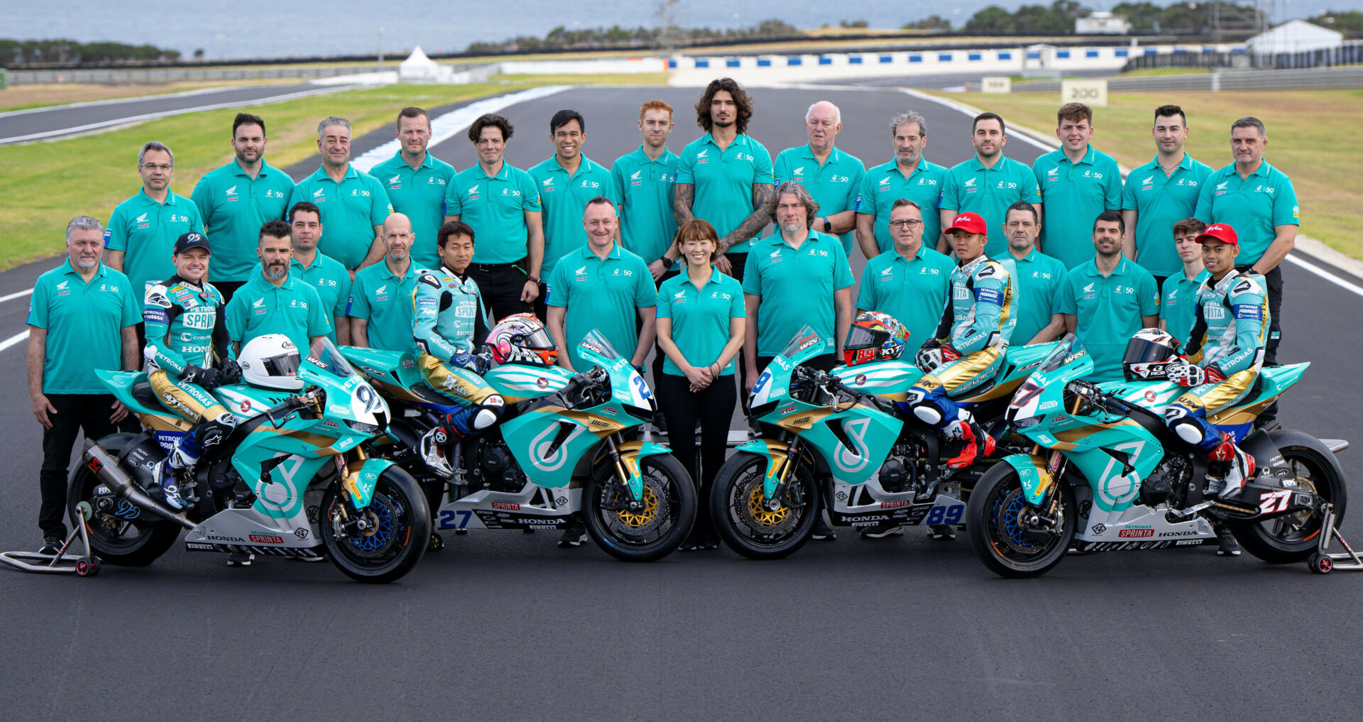 The PETRONAS MIE Racing Honda Team with Team Owner Midori Moriwaki (front center) and riders (from left) Tarran Mackenzie, Kaito Toba, Khairul Idham Bin Pawi, and Adam Norrodin. Photo courtesy PETRONAS MIE Racing Honda Team.