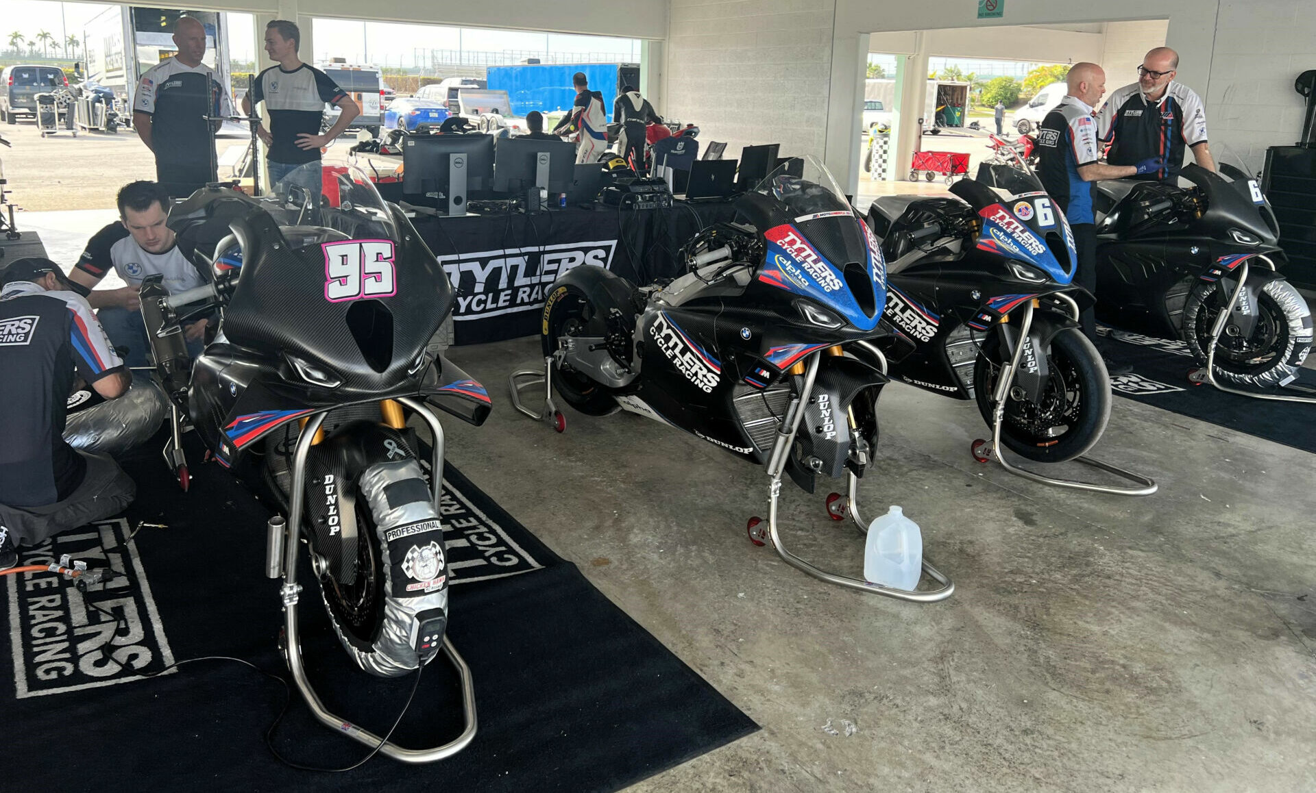 The Tytlers Cycle Racing MotoAmerica Superbike team and its BMW M 1000 RR Superbikes set up in a garage at Homestead-Miami Speedway. Team Manager/Crew Chief Dave Weaver can be seen at the far right. Photo by Steve Guanche.