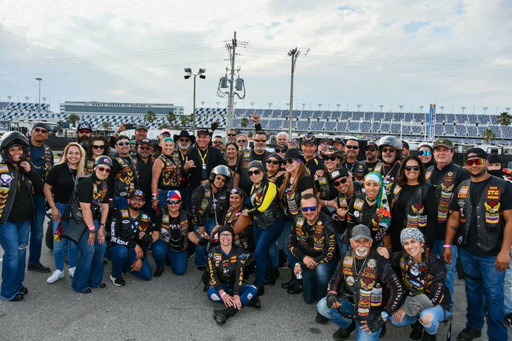 Attorney CJ Czaia (center with solid black shirt and black hat) with members of the Latin American Motorcycle Association at Daytona in 2023. Photo Courtesy of Czaia Law.